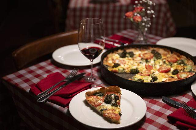The spinoccoli pizza, which is a deep dish pizza consisting of broccoli, seasoned spinach, mozzarella, feta, cheddar, and fresh tomato slices, at Zelda’s in Sacramento on March 9.